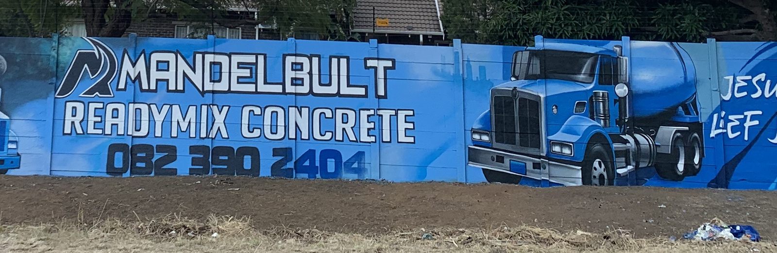 Mandelbult Readymix Concrete branded boundary wall painted in blue